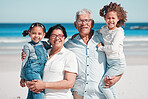 Portrait, travel and happy family at a beach, bonding and having fun outdoors against sea background. Face, seniors and man with woman enjoying retirement with grandchildren on ocean trip in Miami