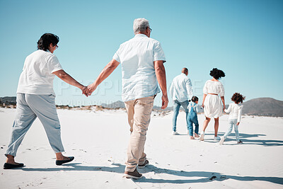 Buy stock photo Elderly couple, holding hands and family at beach with back for walk, freedom and vacation together with love. Old man, woman and grandchildren by ocean for walking, wellness and journey in sunshine