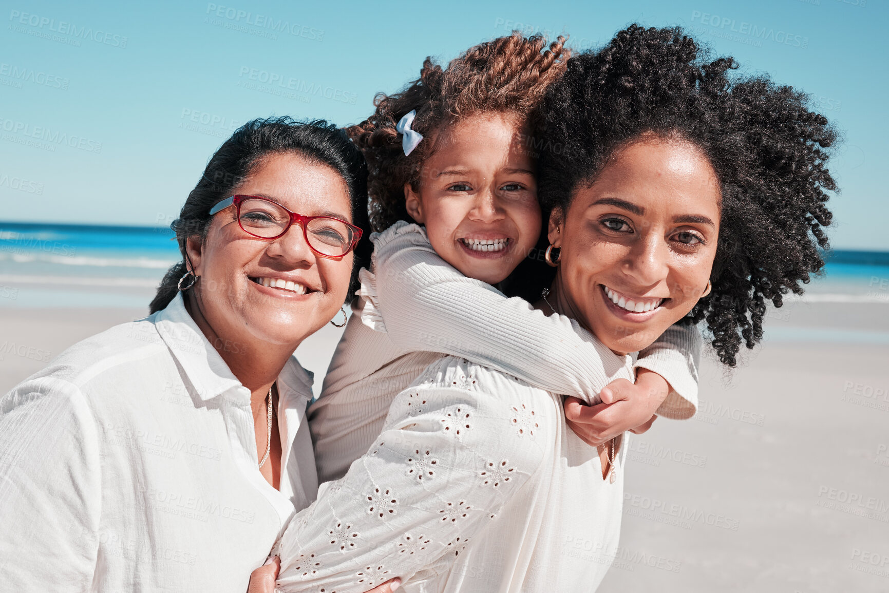 Buy stock photo Portrait, mother and grandmother with girl at beach, smiling and bonding together at seashore. Care, family and happy grandma and mama carrying kid, having fun and enjoying summer time vacation.