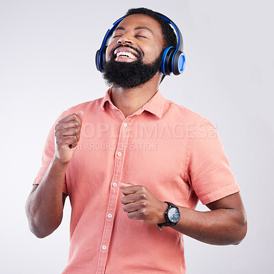 Buy stock photo Music headphones, dance and happy black man streaming song for studio fun, freedom and wellness. Dancing energy, audio podcast and person listening to radio, media sound or track on white background