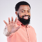 Black man, hand and stop in studio portrait with smile, sign language and communication by background. Young african model, signal or symbol for opinion, protest palm and voice with confident pride