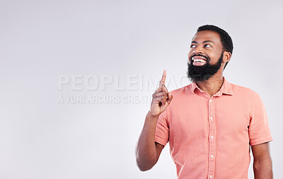 Buy stock photo Point, studio and black man with mockup space and hand gesture for product placement, advertising and sign. Happy, smile and male thinking on white background pointing up for choice, branding or show