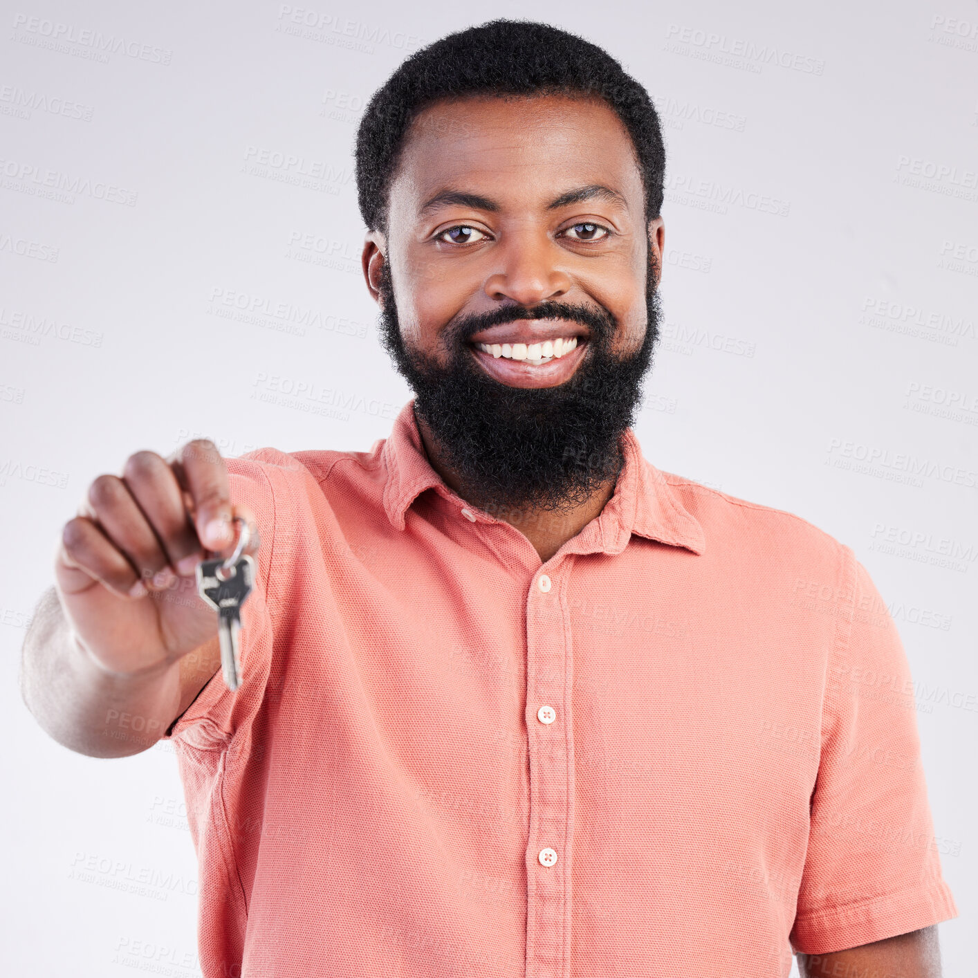 Buy stock photo Real estate, happy and portrait of a black man with keys isolated on a white background in a studio. Smile, pride and African guy showing a key to a new home, house or apartment as a property owner