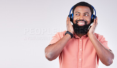 Buy stock photo Black man, studio mockup space and headphones for music to relax, listen and streaming by background. Happy african model, audio and sound for peace, mindfulness and online podcast with smile on face