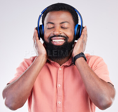 Buy stock photo Black man, studio and headphones for streaming music to relax, listen and free mindset by background. Happy african model, audio and sound for peace, mindfulness and online podcast with smile on face