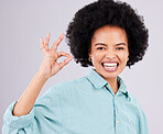 Woman, afro and portrait smile with ok sign for satisfaction, approval or agreement against gray studio background. Happy female smiling and showing okay hand emoji, symbol or gesture for perfection