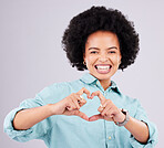 Black woman, studio portrait and heart hands with beauty, afro and smile for romance, love and confidence. Happy african, model and emoji with happiness, fashion or romantic sign by gray background