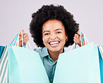 Shopping bags, retail portrait and happy black woman with luxury sales product, designer fashion deal or mall store present. Commerce market, discount gift and studio customer face on gray background