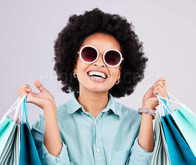 Buy stock photo Shopping bag, retail glasses and happy black woman with luxury sales product, designer fashion deal or mall store present. Commerce market, discount gift and studio customer face on gray background