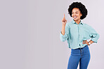 Mockup, copy space and black woman point in studio for advertising, product placement and branding. Happy, smile and isolated female pointing on white background for show, choice and promotion sign