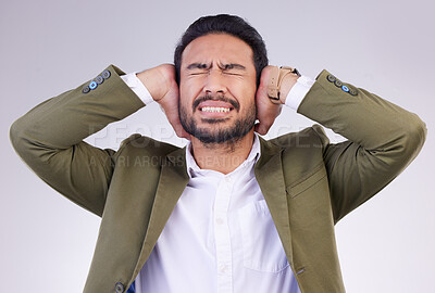 Buy stock photo Business, stress and Asian man cover ears, loud and mental health against a grey studio background. Male employee, anxious worker and entrepreneur with hands on temple, noisy and blocking for silence