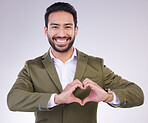 Hands, heart shape and business man portrait in studio for support, love and charity on a gray background. Asian entrepreneur person with hand emoji or icon for care, motivation and kindness smile