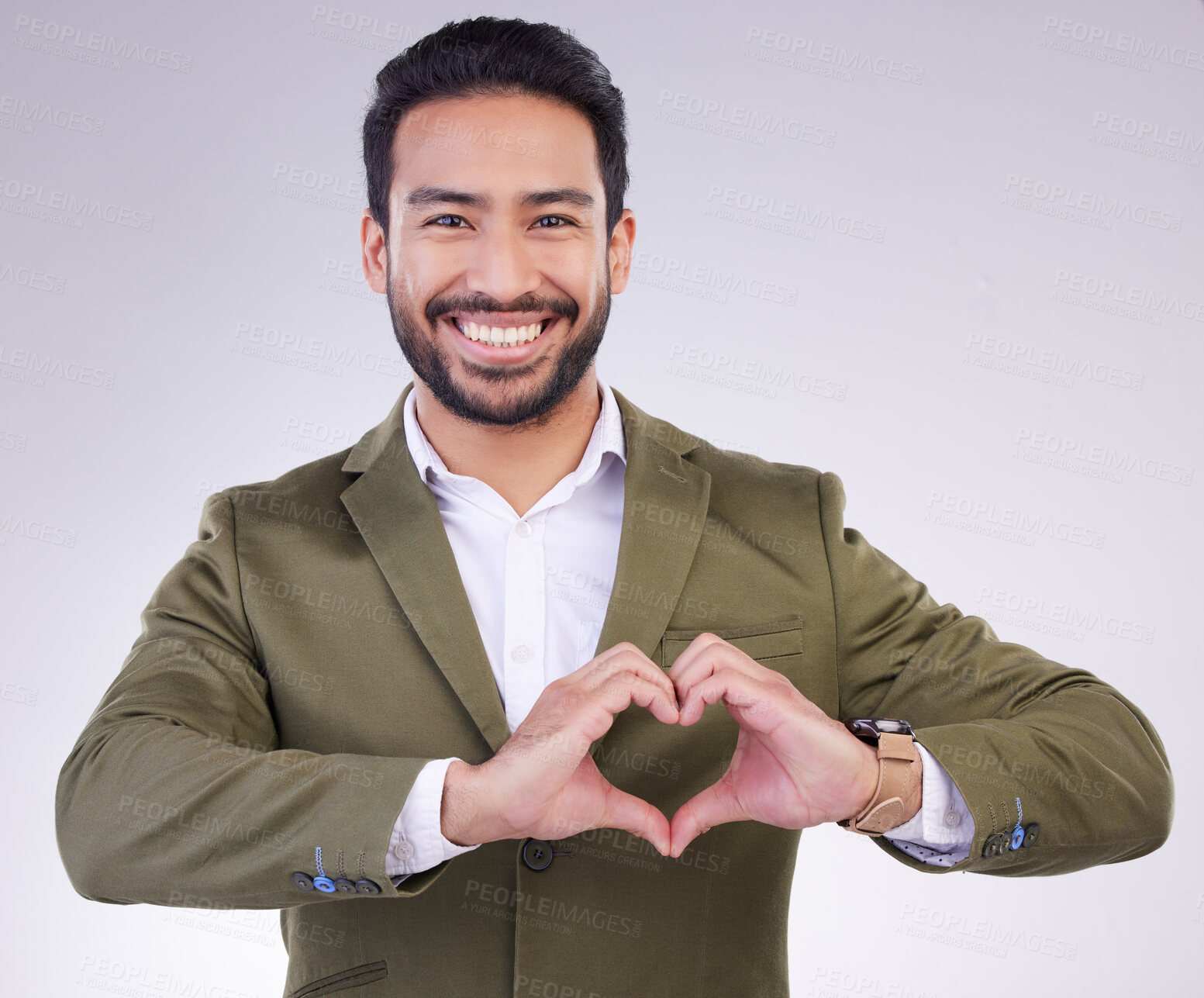 Buy stock photo Hands, heart shape and business man portrait in studio for support, love and charity on a gray background. Asian entrepreneur person with hand emoji or icon for care, motivation and kindness smile