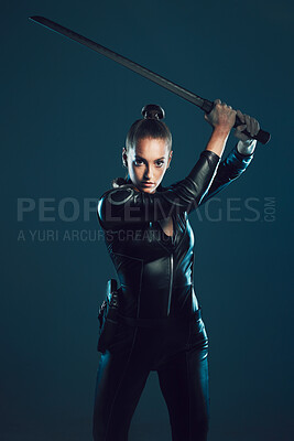 Buy stock photo Woman, warrior and vigilante in cosplay with sword ready for battle, war or game against a dark studio background. Female in black costume or hero with guns and blade for halloween or super power