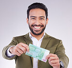 Portrait, money and euro with a business man in studio holding cash on a gray background for finance. Smile, accounting or investment with a happy male employee proud of his financial trading success