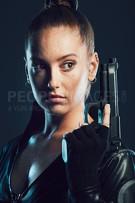 Buy stock photo Woman, warrior and gun in studio with serious face for action, fight and safety from danger. Strong female model, assassin or agent in scifi leather cosplay costume with weapon on a dark background