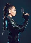 Woman, warrior and gun profile in studio for action, fight and safety from danger. Strong female model, assassin or killer in scifi leather cosplay costume with weapon for action on dark background