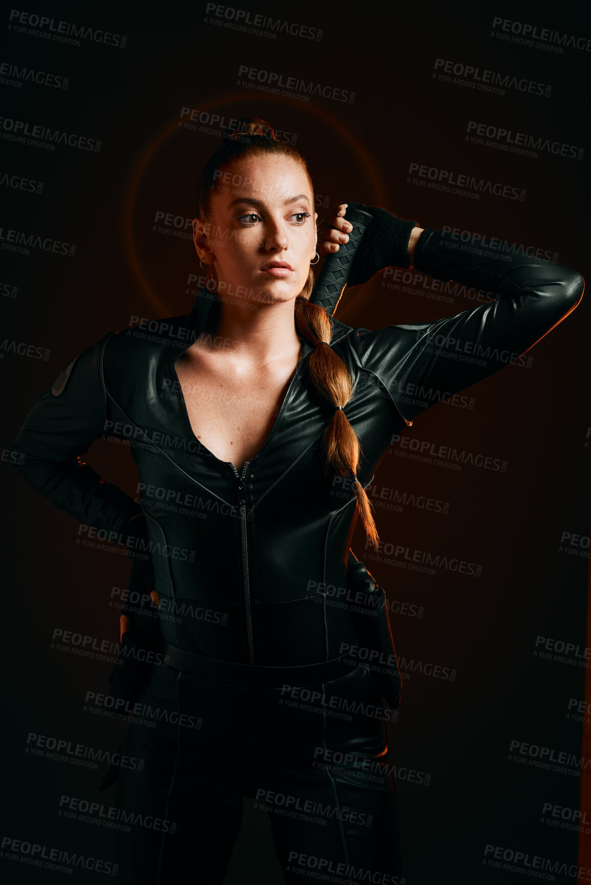 Buy stock photo Woman, warrior and costume of vigilante in cosplay ready for battle, war or game against a dark studio background. Female in black leather uniform with sword and guns for halloween or hunger games