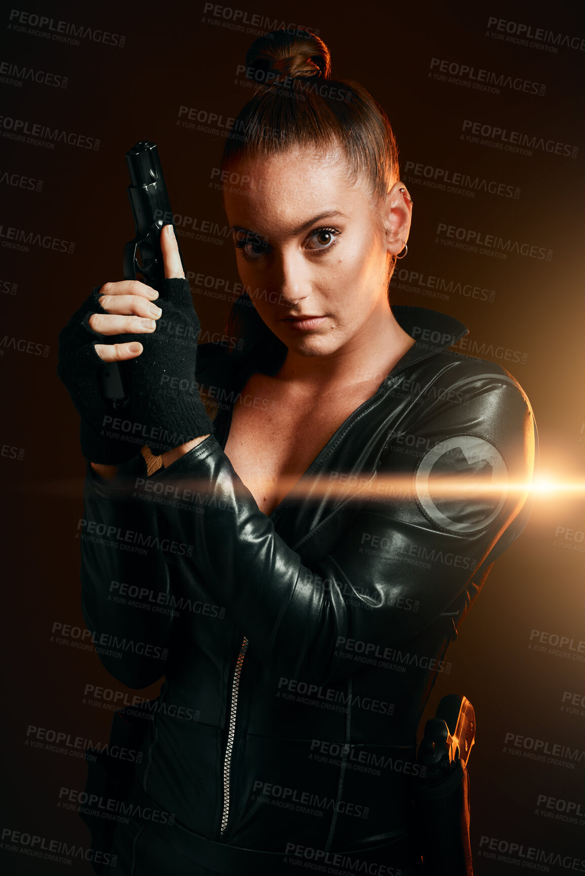 Buy stock photo Portrait, gun and secret agent with a woman assassin in studio on a dark background ready for combat. Hero, leather and power with an attractive young female spy holding a weapon on a mission