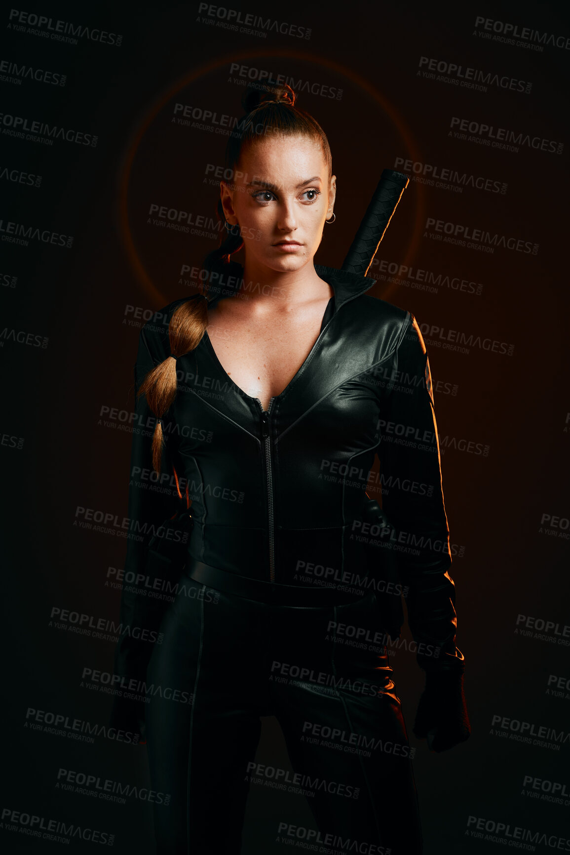 Buy stock photo Woman, warrior and fashion outfit in studio for action, fight and safety from danger in a dark studio. Strong female model, assassin or killer in scifi leather cosplay costume with weapon for action