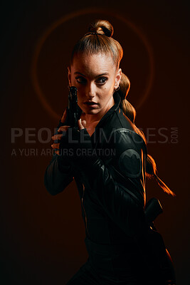 Buy stock photo Woman, warrior and gun to fight in studio for action and safety from danger on dark background. Strong female model, assassin or agent in scifi cosplay costume with weapon for action and defense