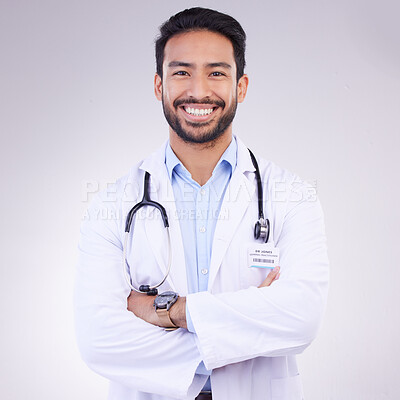 Buy stock photo Doctor, man with arms crossed in portrait and smile, health and medical professional on studio background. Male physician, cardiovascular surgeon with stethoscope, happiness in medicine and mockup