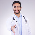 Doctor, man and handshake for healthcare partnership, meeting or greeting against a gray studio background. Portrait of happy male medical professional shaking hands for introduction or thank you