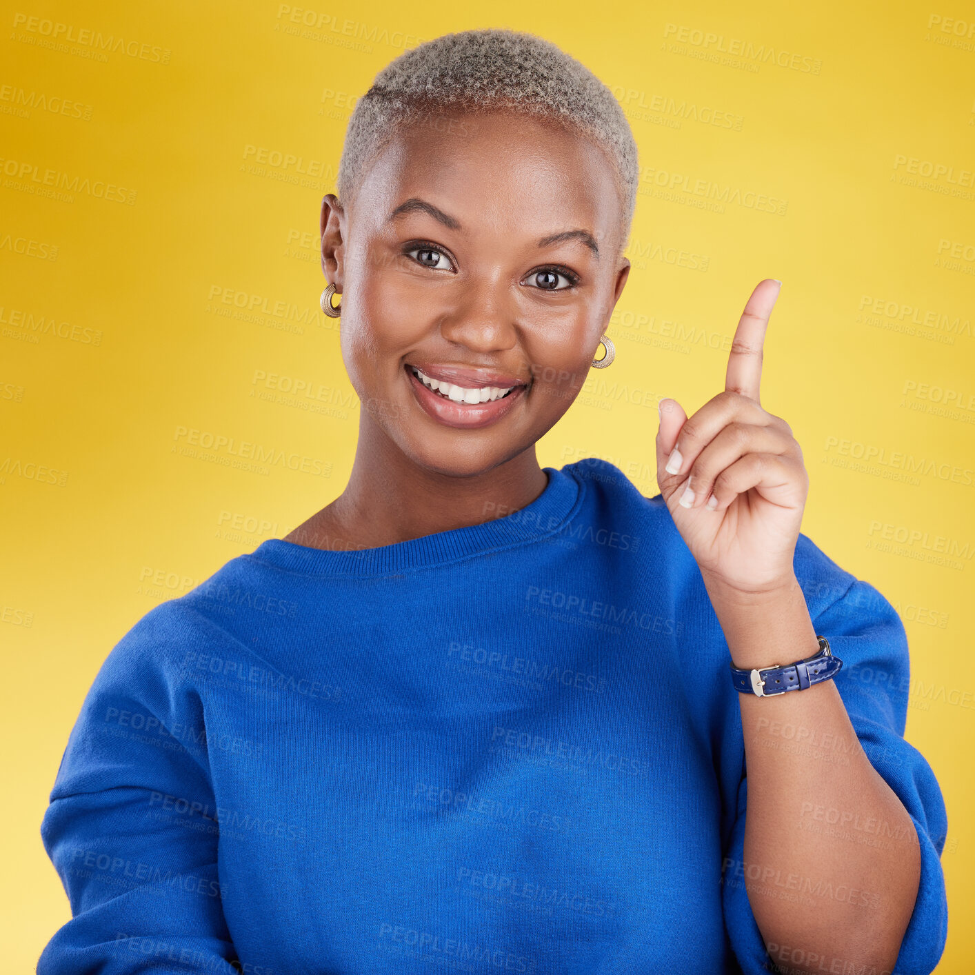 Buy stock photo Smile, portrait and black woman in studio pointing up at product placement, mockup or information. Deal, promotion or announcement, happy model showing info space or notification on yellow background