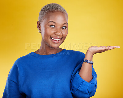 Buy stock photo Portrait, smile and black woman with product placement palm in studio isolated on a yellow background. Mockup face, happy and African female with hand for advertising, marketing or branding space.