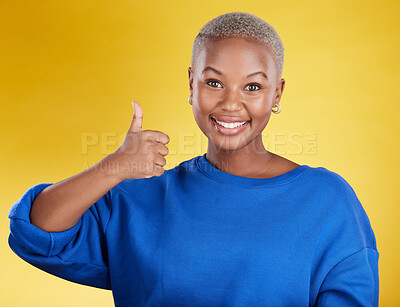 Buy stock photo Portrait, smile and black woman with thumbs up in studio isolated on a yellow background. Success, emoji face and happy African female with hand gesture for agreement, support or approval, like or ok
