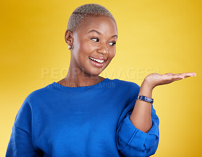 Buy stock photo Mock up, smile and black woman with product placement in studio isolated on a yellow background. Mockup promotion, happy and African female with palm for advertising, marketing and branding space.