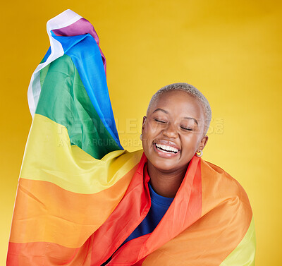 Buy stock photo Laughing, lgbtq and black woman with pride flag in studio isolated on a yellow background. Gay, homosexual and lesbian, queer or funny, happy or comic African female with banner for trans or bisexual