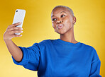 Selfie, smile and beauty of black woman in studio isolated on a yellow background. Photographer, social media and African female model taking pictures or photo for profile picture and happy memory.
