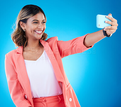 Buy stock photo Selfie, smile and business woman in studio isolated on a blue background. Photographer, professional and Indian female entrepreneur taking photo for happy memory, social media and profile picture.