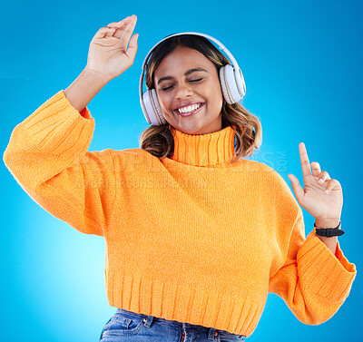 Buy stock photo Music headphones, smile and woman dance in studio isolated on a blue background. Dancing, radio and happy Indian female with eyes closed streaming, listening and enjoying sound, audio podcast or song