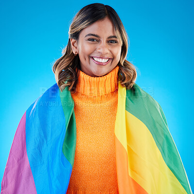 Buy stock photo Portrait, pride and woman with rainbow flag, queer and acceptance against a blue studio background. Face, female and happy girl with symbol for lgbtq community, equality and transgender with support