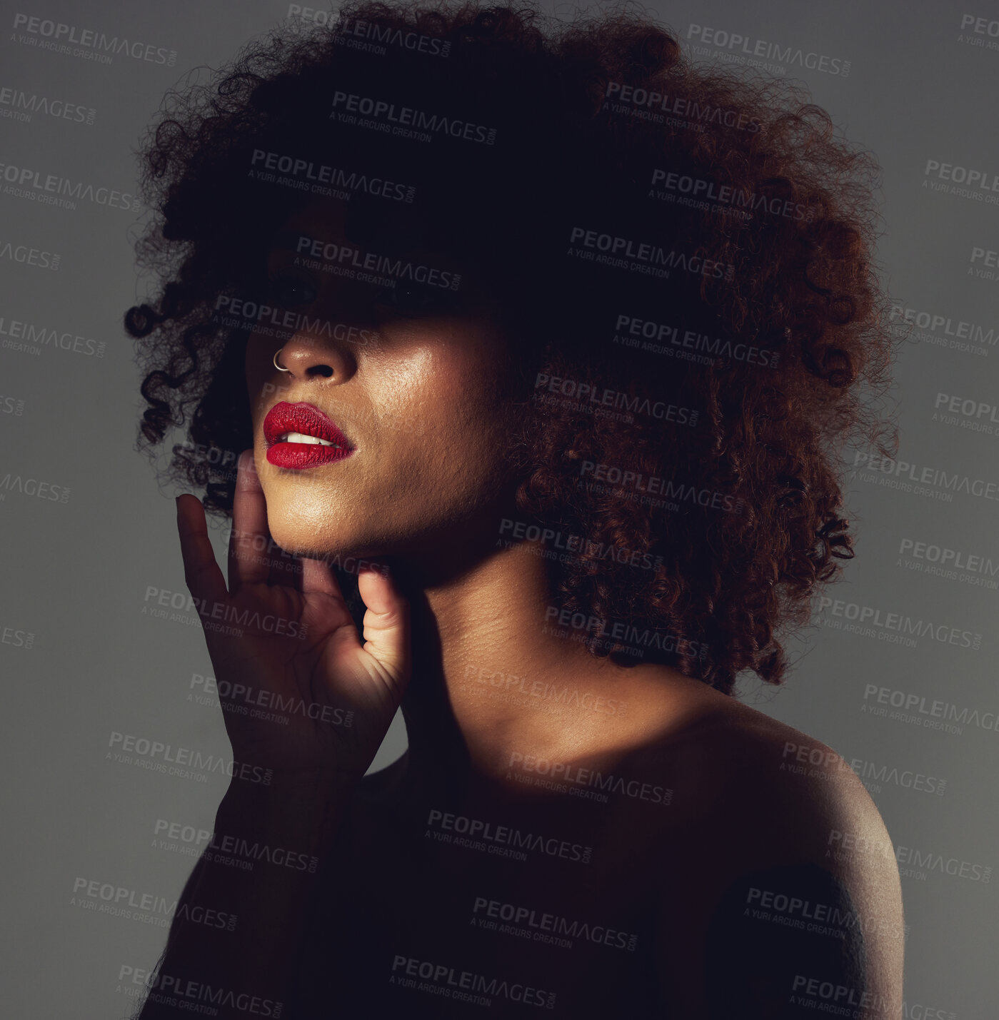 Buy stock photo Makeup, red lipstick and shadow of black woman with beauty, afro or natural hair in studio. Face of aesthetic female model with a skin glow, shine and color on lips for art, power and facial skincare