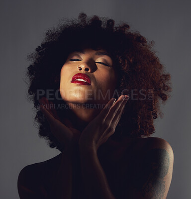Buy stock photo Black woman, shadow and makeup or red lipstick with beauty, afro or natural hair in studio. Face of aesthetic female model with hands to show skin glow, shine and color on lips for art and skincare