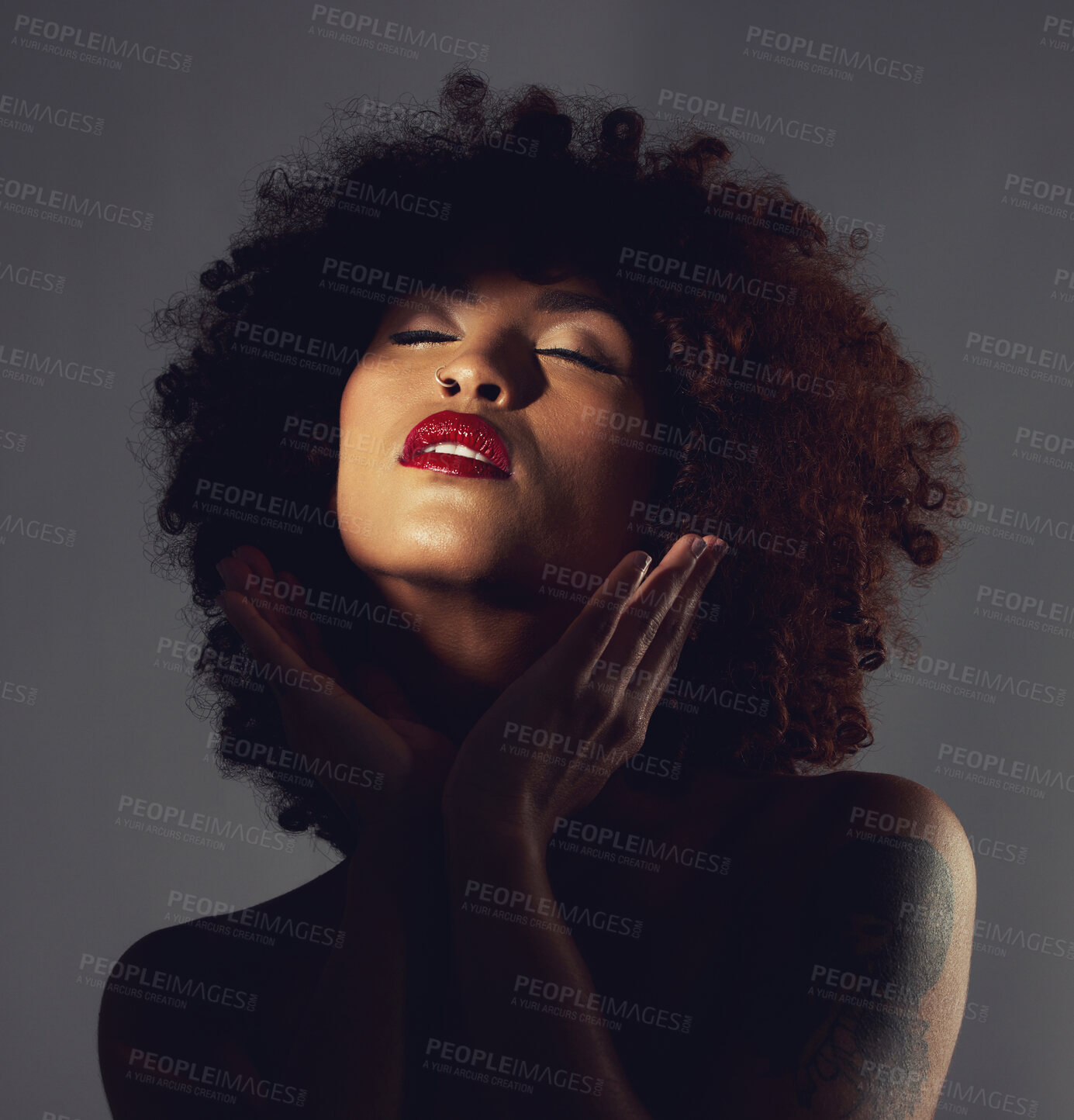 Buy stock photo Black woman, shadow and makeup or red lipstick with beauty, afro or natural hair in studio. Face of aesthetic female model with hands to show skin glow, shine and color on lips for art and skincare