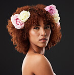 Face, beauty and flowers with a model black woman in studio on a dark background for natural skincare. Wellness, luxury and portrait with an attractive young female wearing a flower crown or wreath