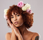 Portrait, skincare and flowers with a model black woman in studio on a gray background for natural beauty. Wellness, luxury and face with an attractive young female wearing a flower crown or wreath