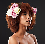 Face, skincare and flowers with a model black woman in studio on a dark background for natural beauty. Wellness, luxury and portrait with an attractive young female wearing a flower crown or wreath