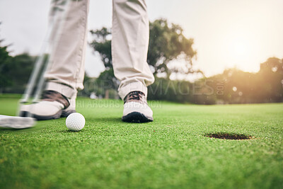 Buy stock photo Golf, hole and legs of athlete or player hit ball and professional golfer training and putting on a filed as exercise or workout. Feet, equipment and gentleman or person relax and playing a sport