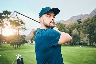 Buy stock photo Golf, focus and hobby with a sports man swinging a club on a field or course for recreation and fun. Golfing, grass and stroke training with a male golfer playing a game on a green during summer