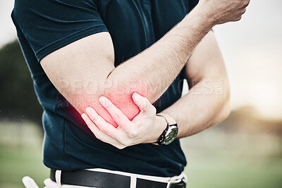 Buy stock photo Sports, elbow pain and man on golf course holding arm during game massage and relief in health and wellness. Green, zoom on hands on muscle for support and golfer with ache during golfing workout.