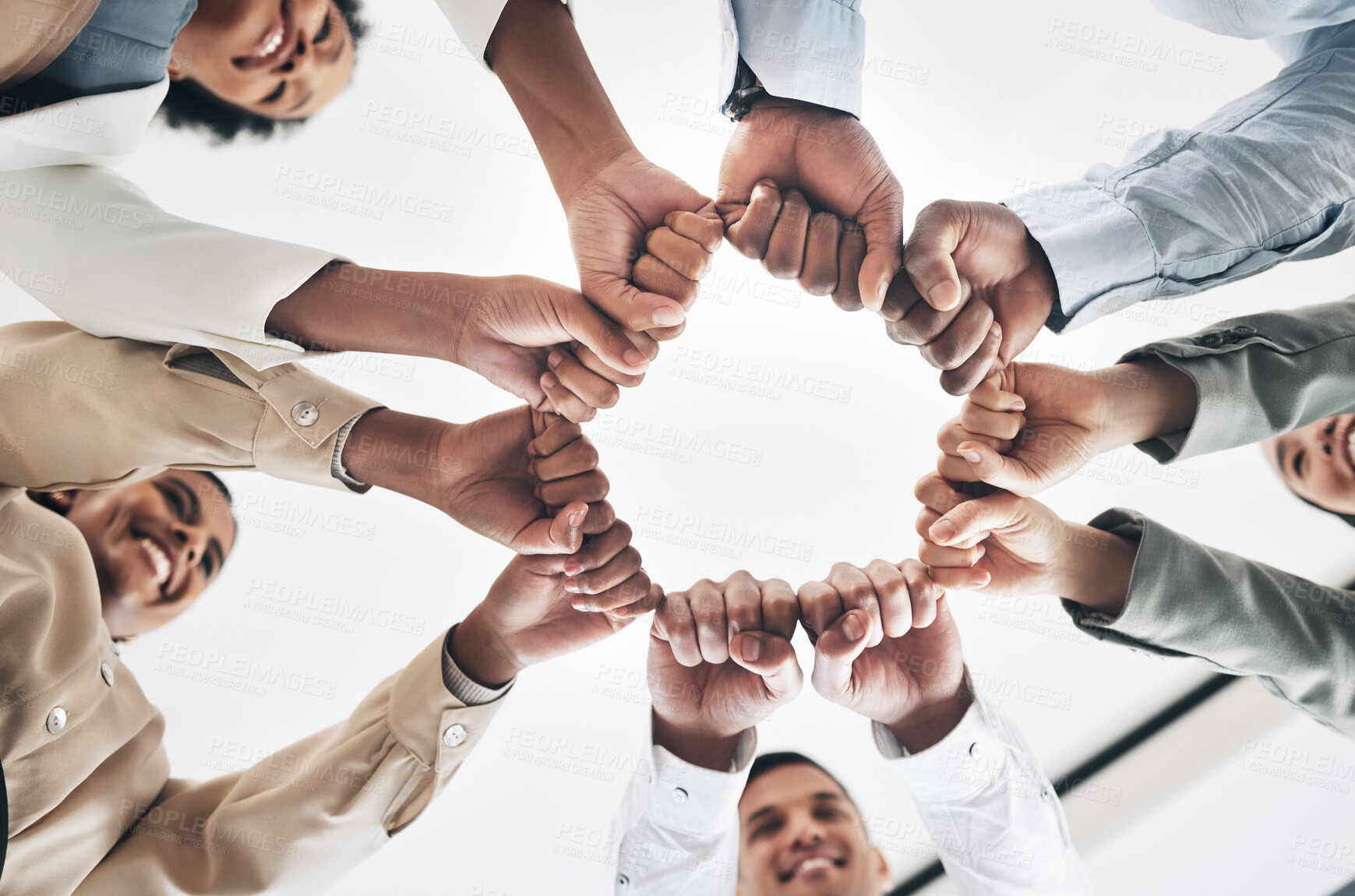 Buy stock photo Team building, circle or happy business people fist bump for motivation in office meeting together. Diversity, low angle or employees with mission, strategy or group support for  project goal
