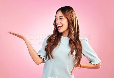 Buy stock photo Young woman show palm isolated on pink background for product placement in beauty and fashion lifestyle. Biracial person or model hand holding empty space for promotion, sale and studio mockup