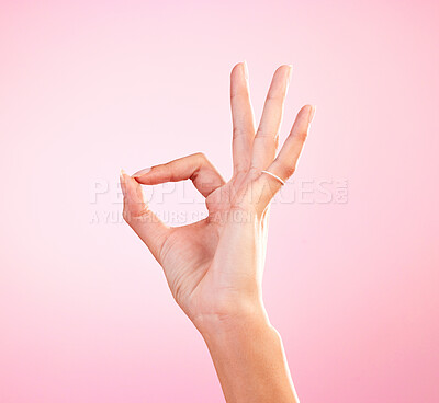 Buy stock photo Hand, perfect and ok sign or emoji in studio for motivation, review and yes or agreement for support. Woman icon, gesture or fingers for approval, communication or decision on mockup pink background