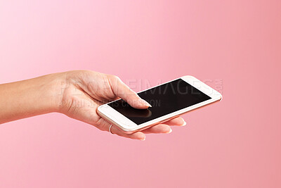 Buy stock photo Phone mockup, hands and screen in studio isolated on a pink background. Cellphone, social media and woman with mobile smartphone for branding, advertising or marketing for product placement space.
