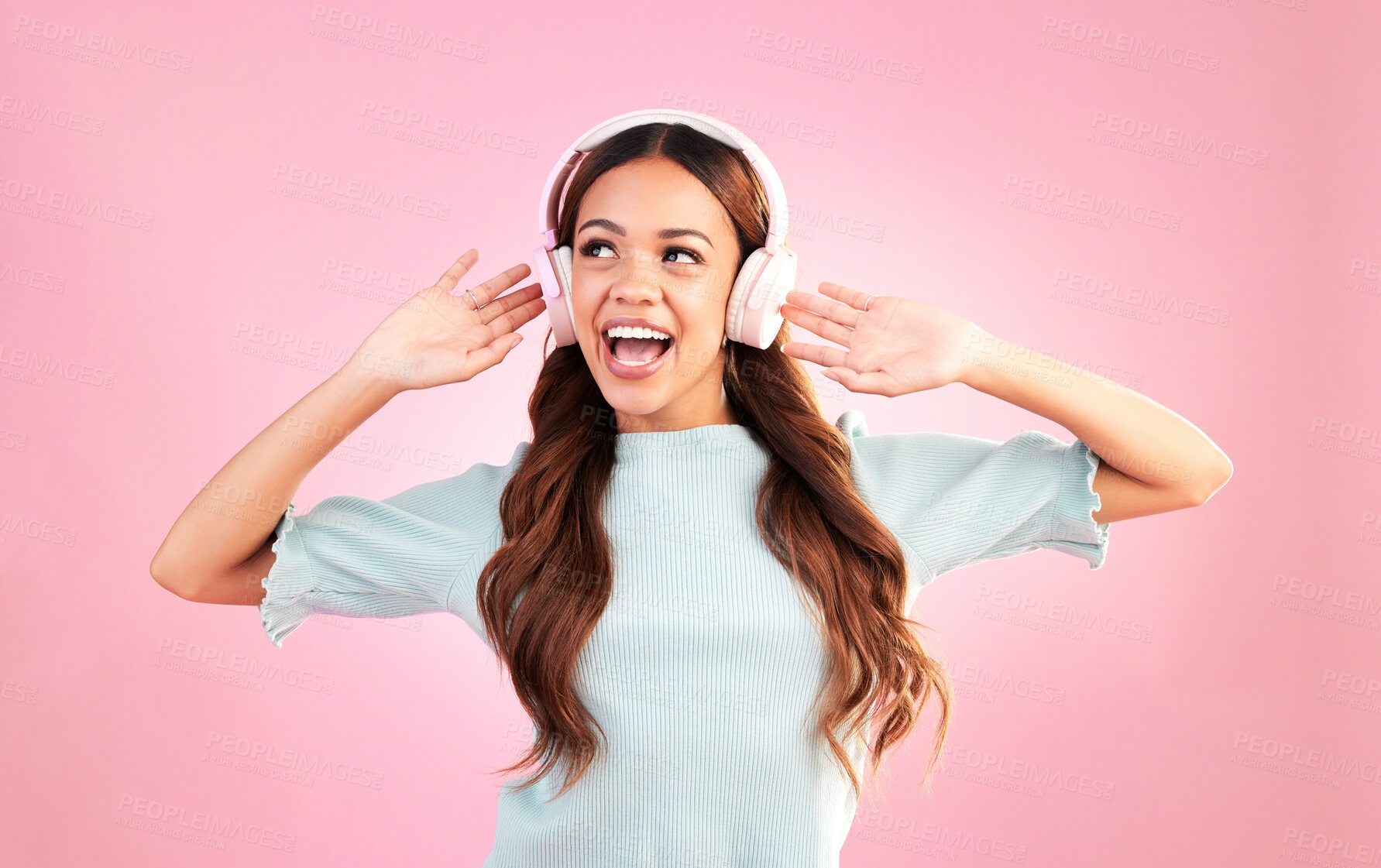 Buy stock photo Music headphones, singing and woman dancing in studio isolated on a pink background. Singer, radio dance and happy mixed race female streaming, enjoying and listening to audio, sound track or podcast
